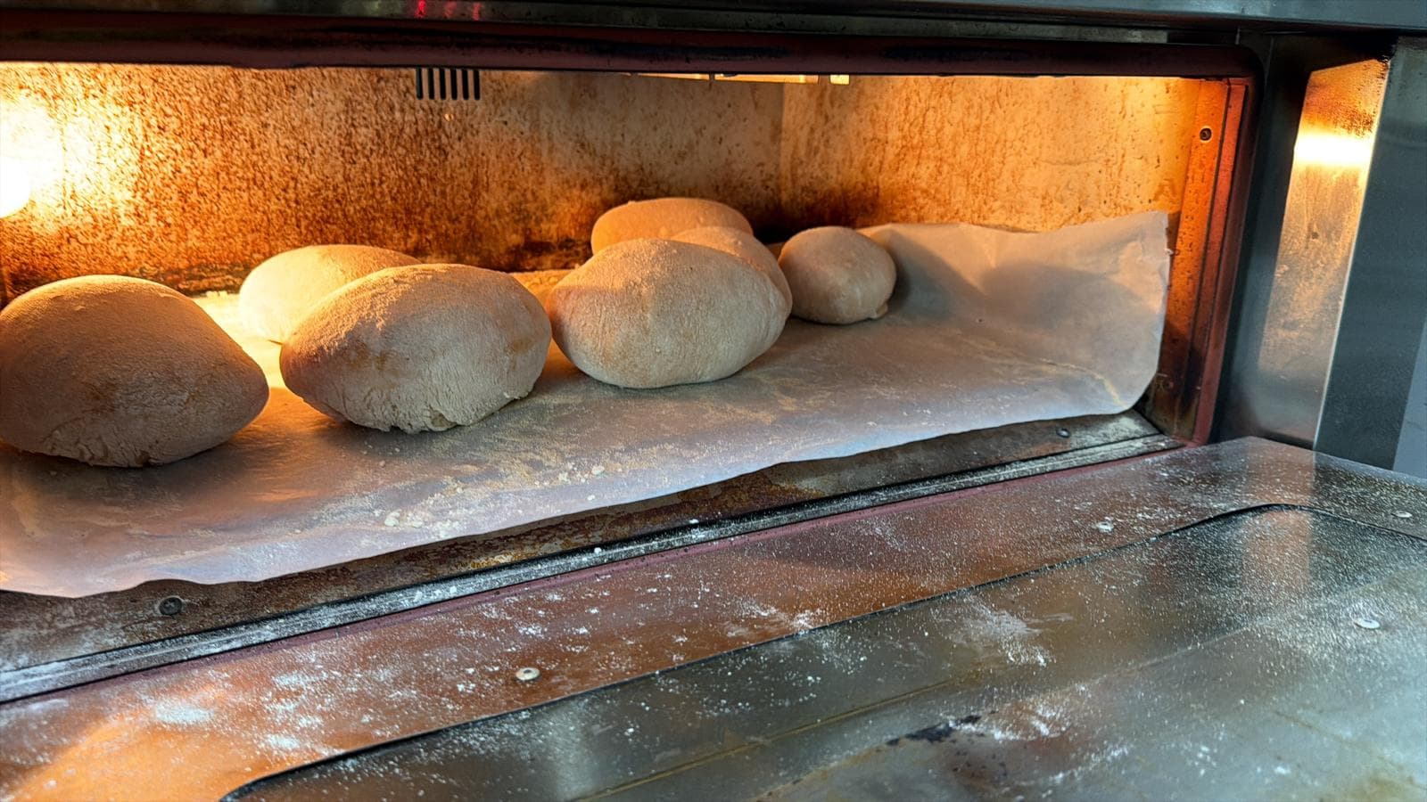 Bread baking inside the oven, golden crust forming